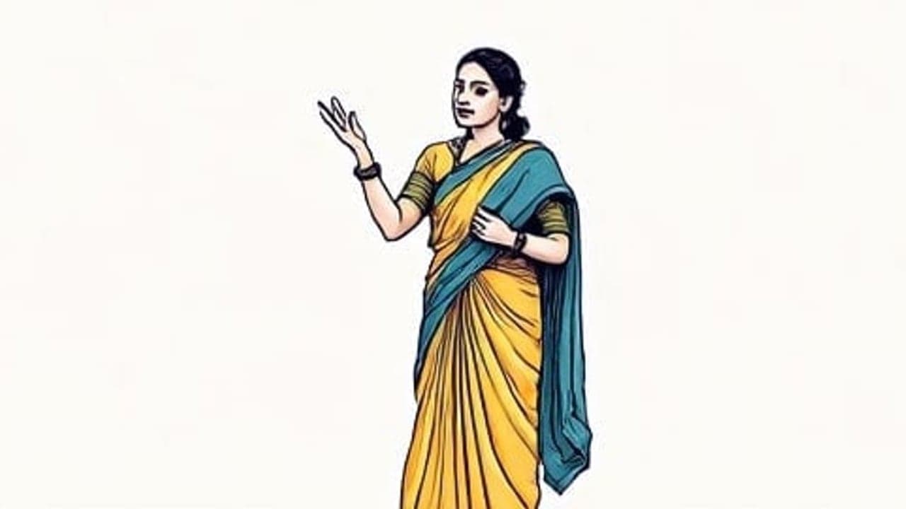 An Indian woman standing and speaking confidently with one hand gesturing